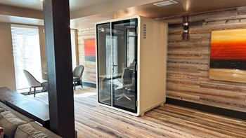 A room with a wooden wall and a glass door.